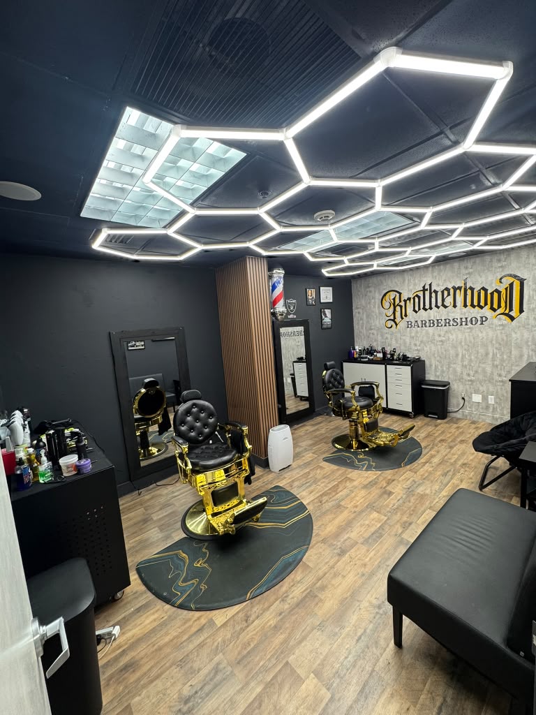 Brotherhood Barbershop interior with gold barber chairs in Deerfield Beach, FL